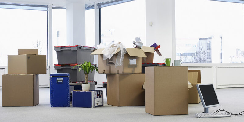 Cartons and equipment on floor of empty office space